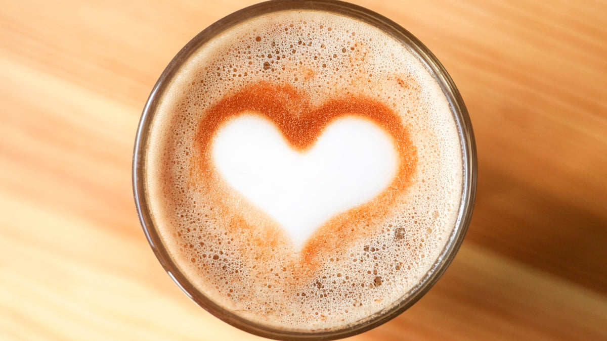 Barista pouring plant milk into coffee