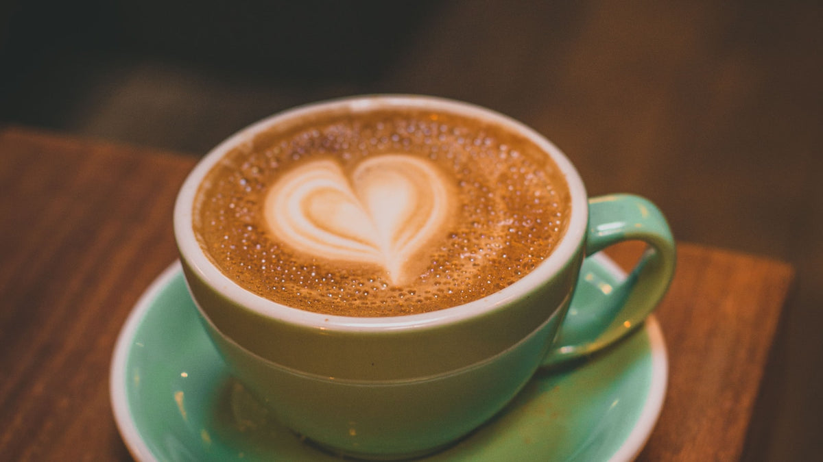 A green cup of coffee on a saucer